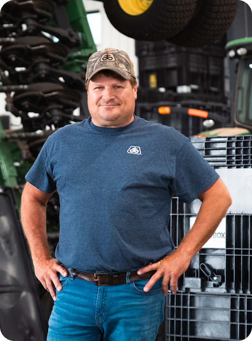 Man standing in front of tractors.
