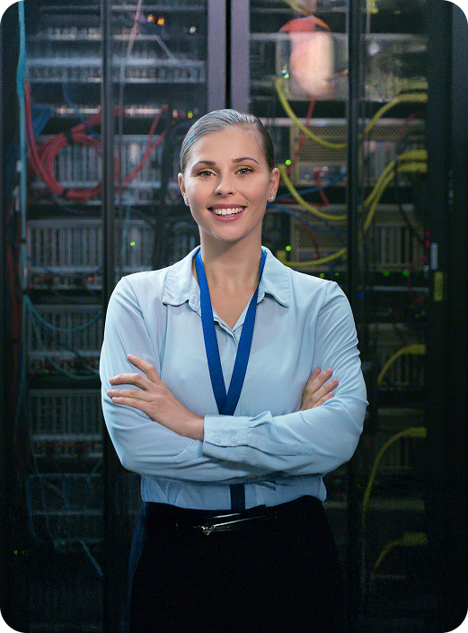 Woman standing in front of computer servers.