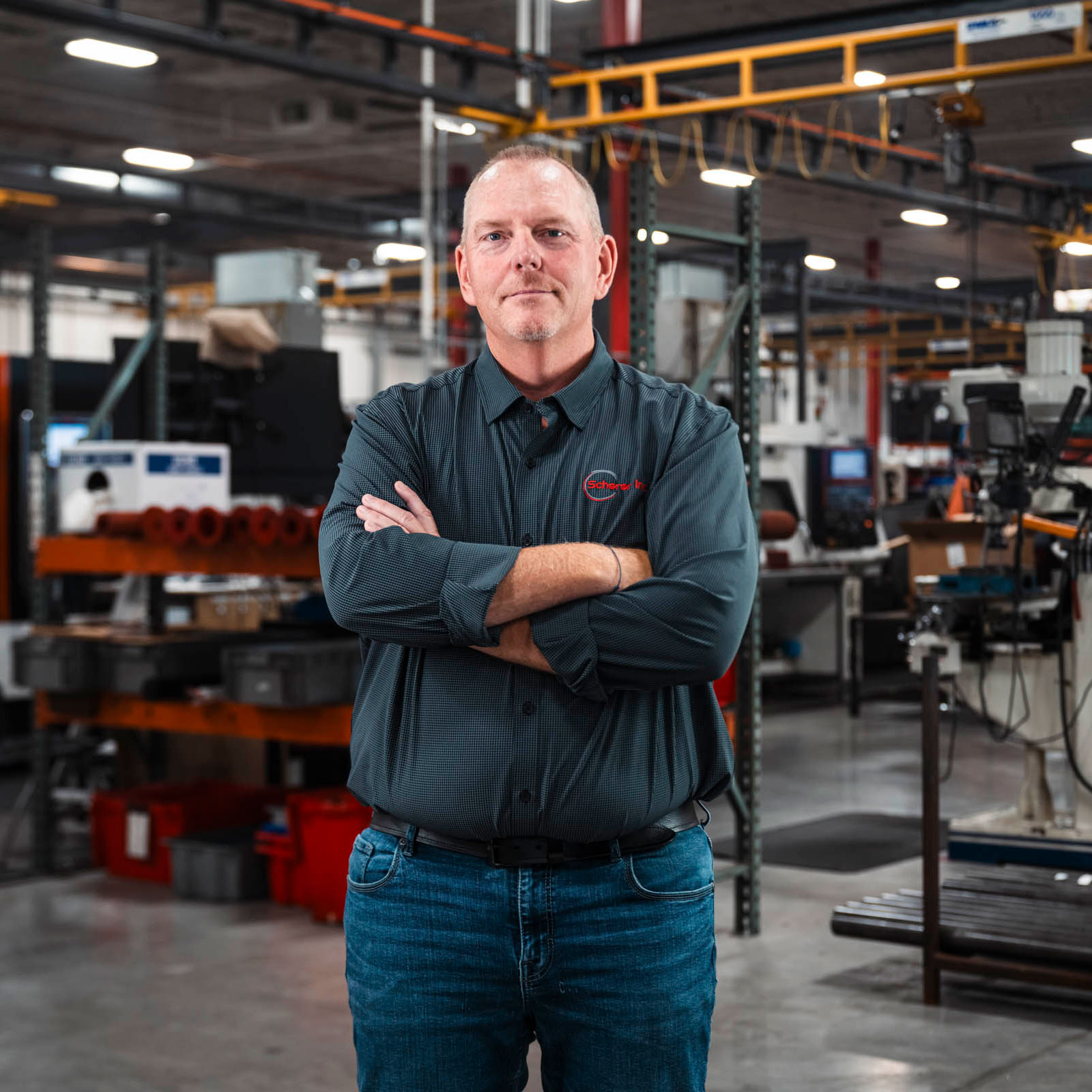 Man standing in manufacturing facility.