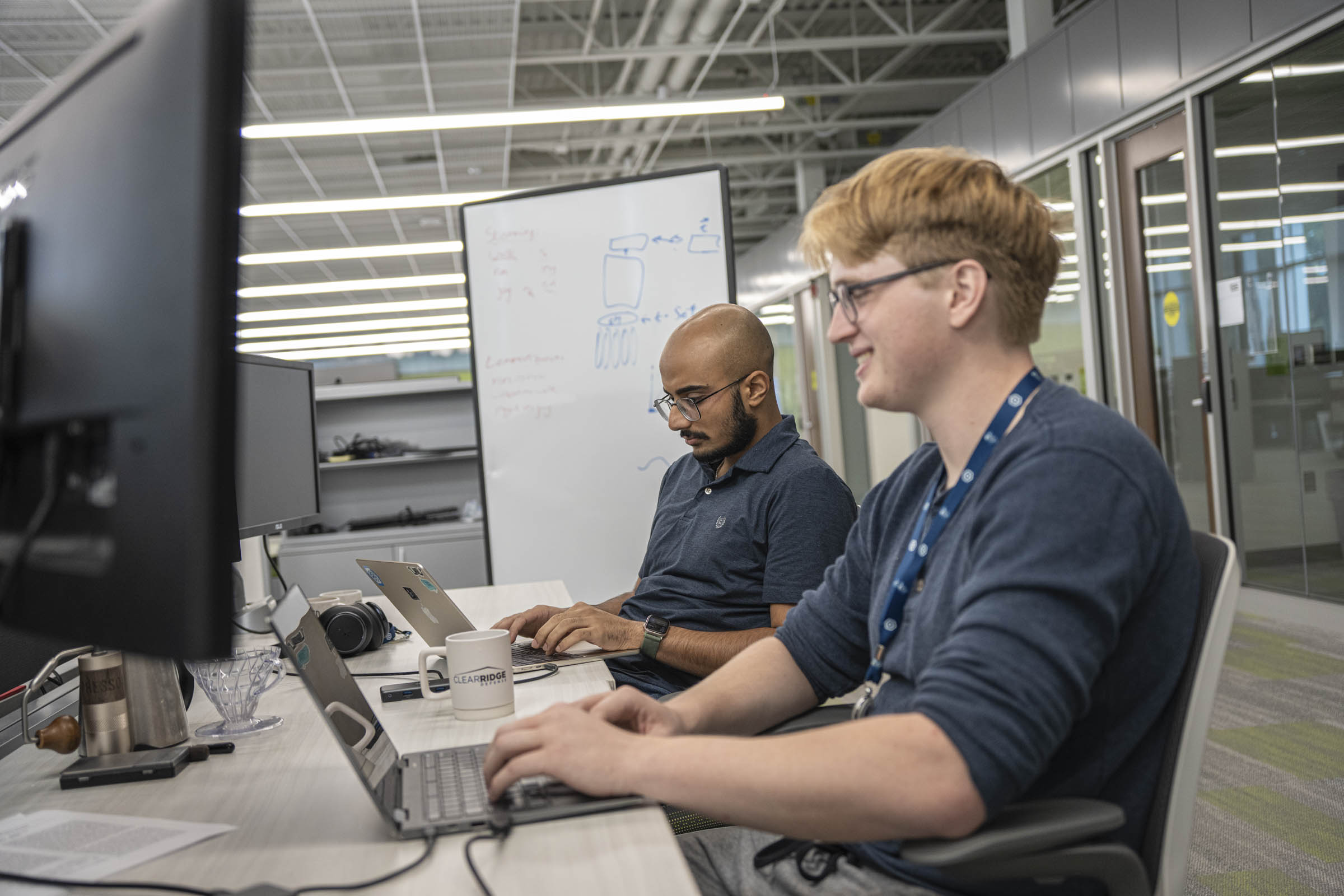People sitting at computer desks.