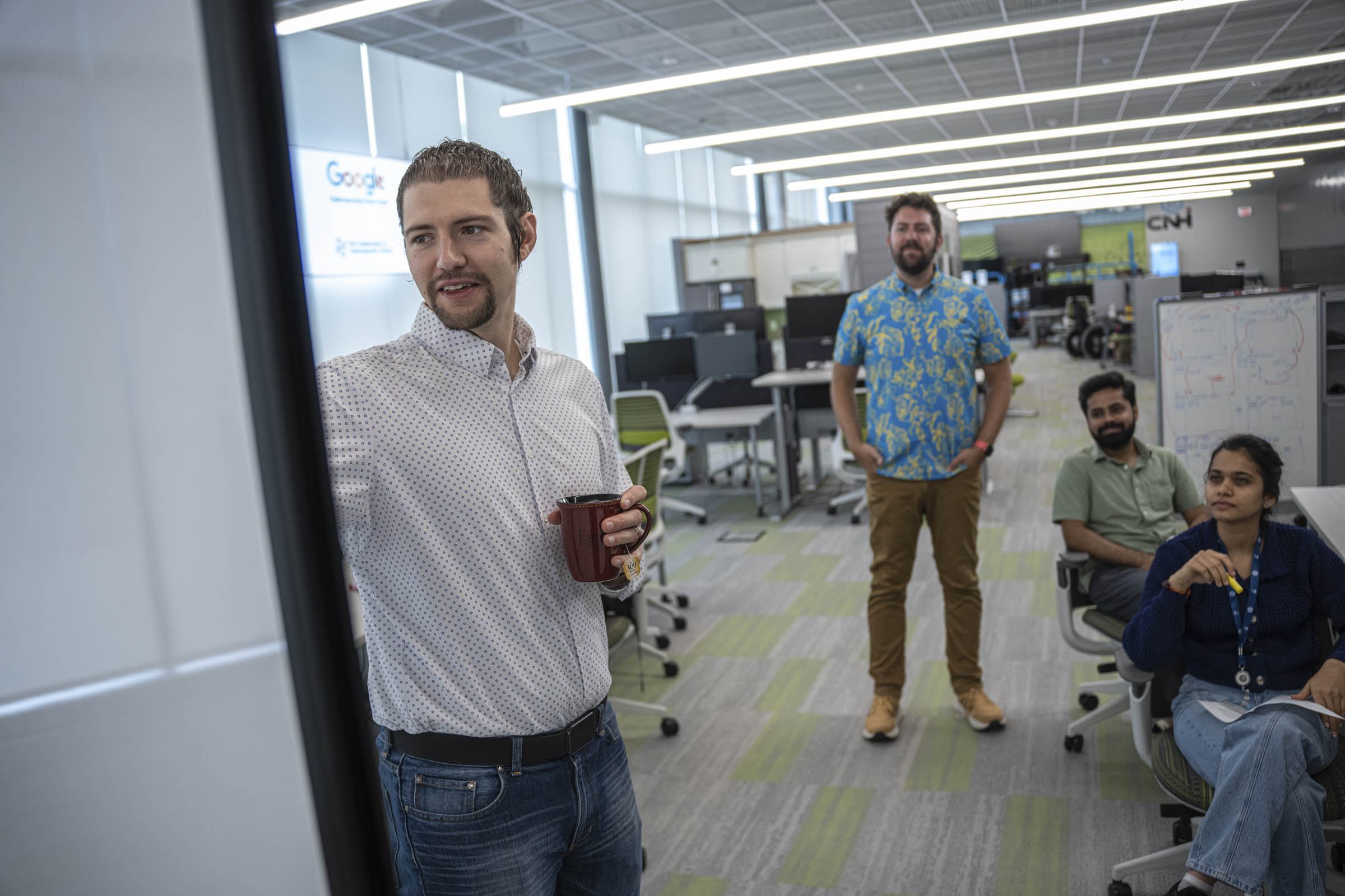 People sitting at computer desks and watching a presentation.