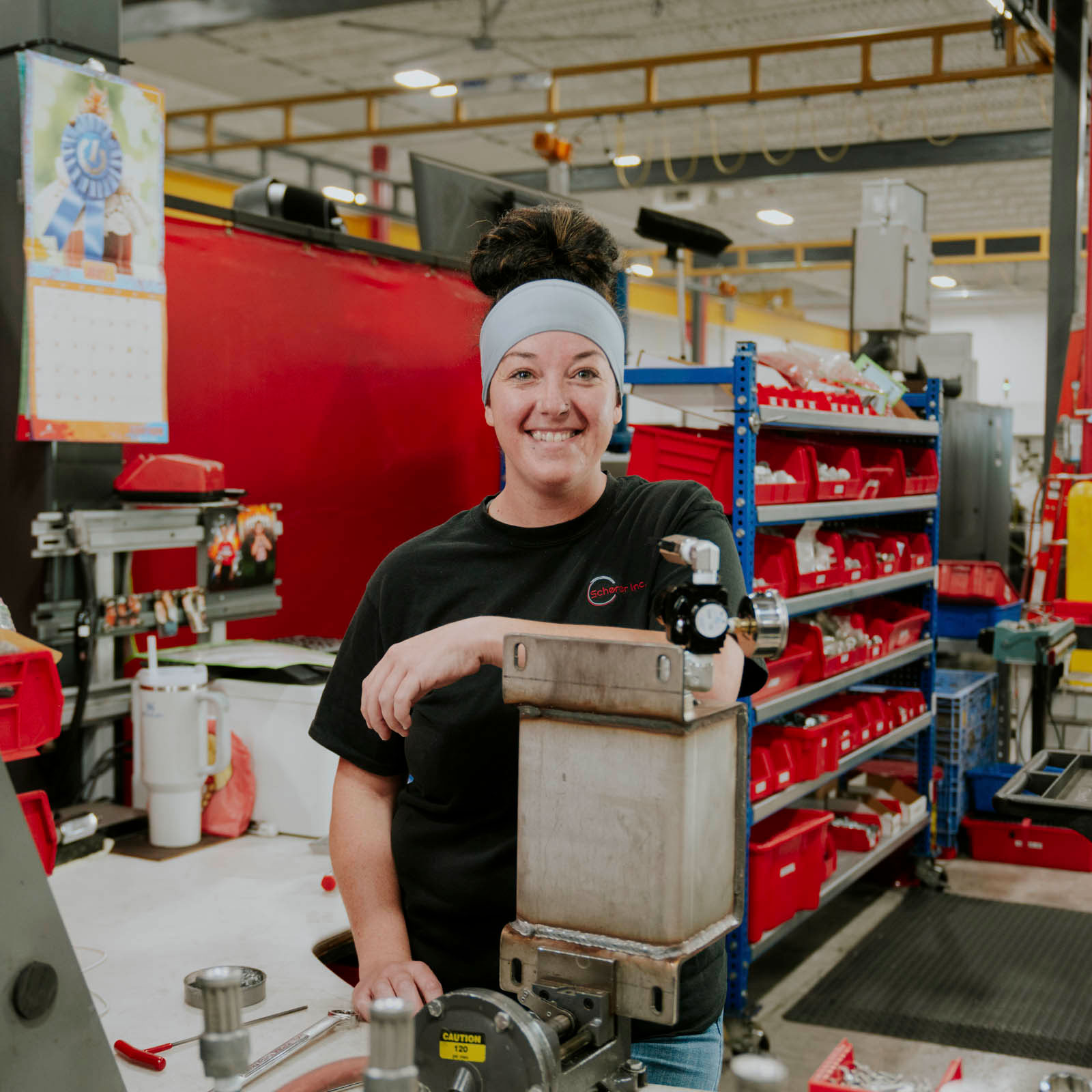 Woman standing in manufacturing facility.