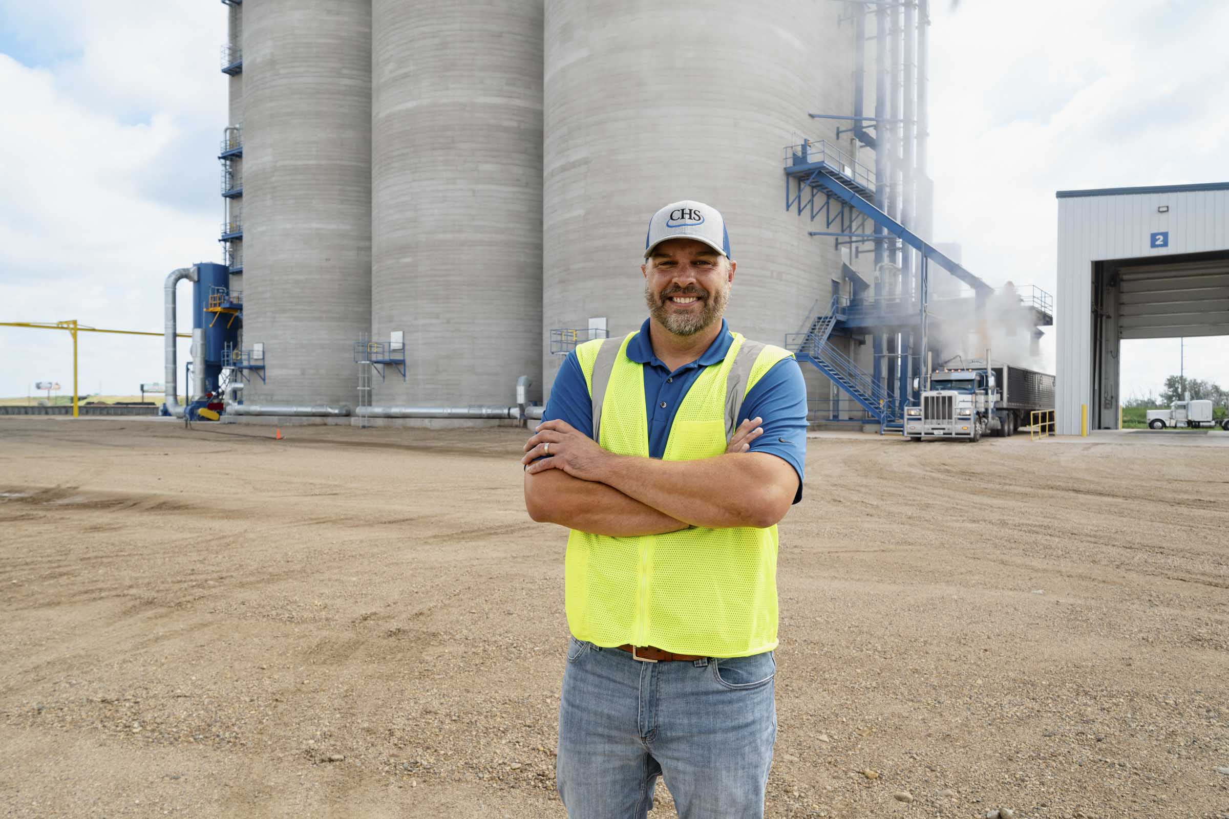 Man standing outside manufacturing facility.