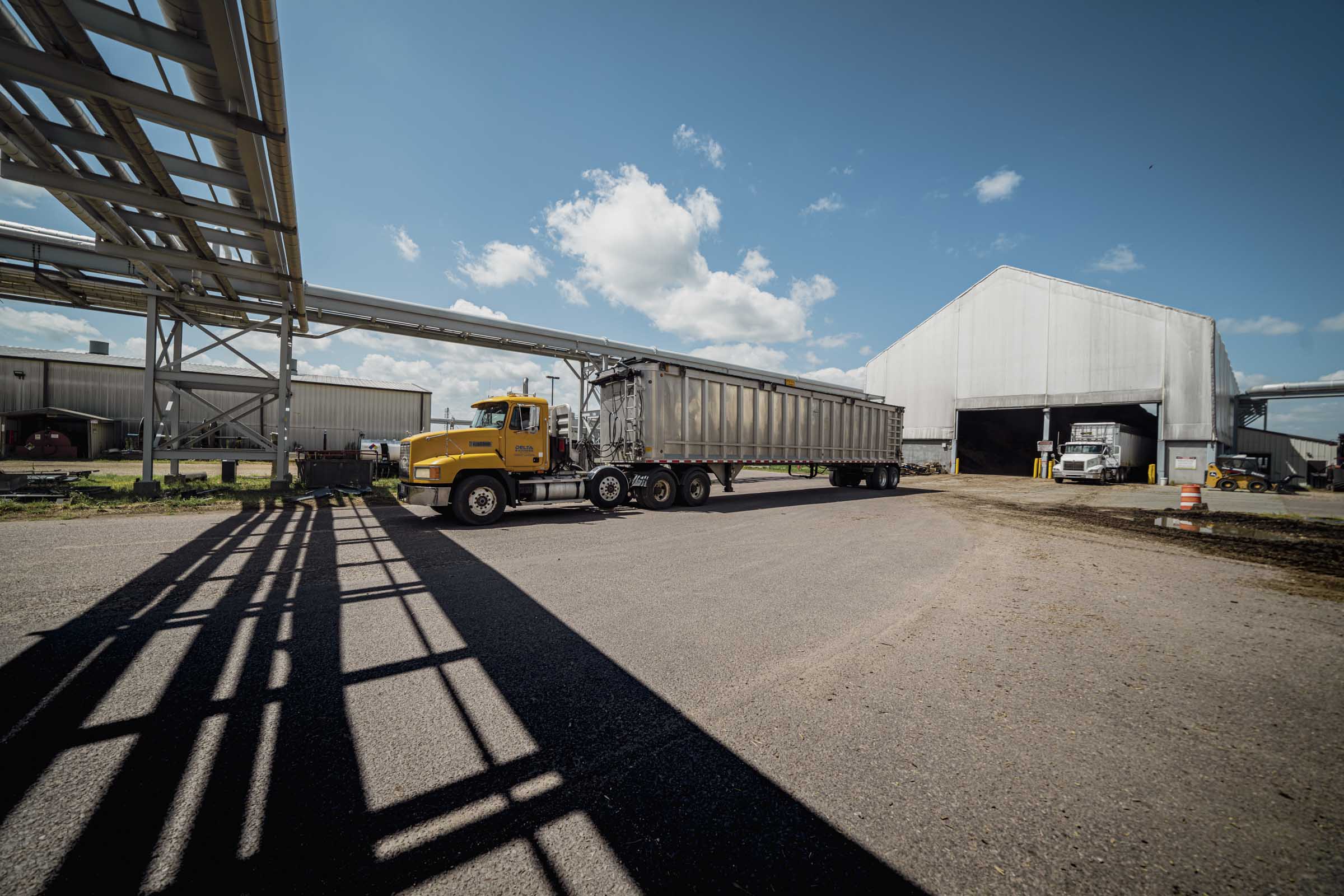 Trucks outside at manufacturing facility.