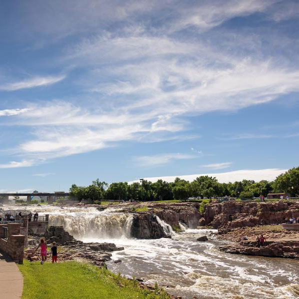 People enjoying a riverside park in South Dakota.