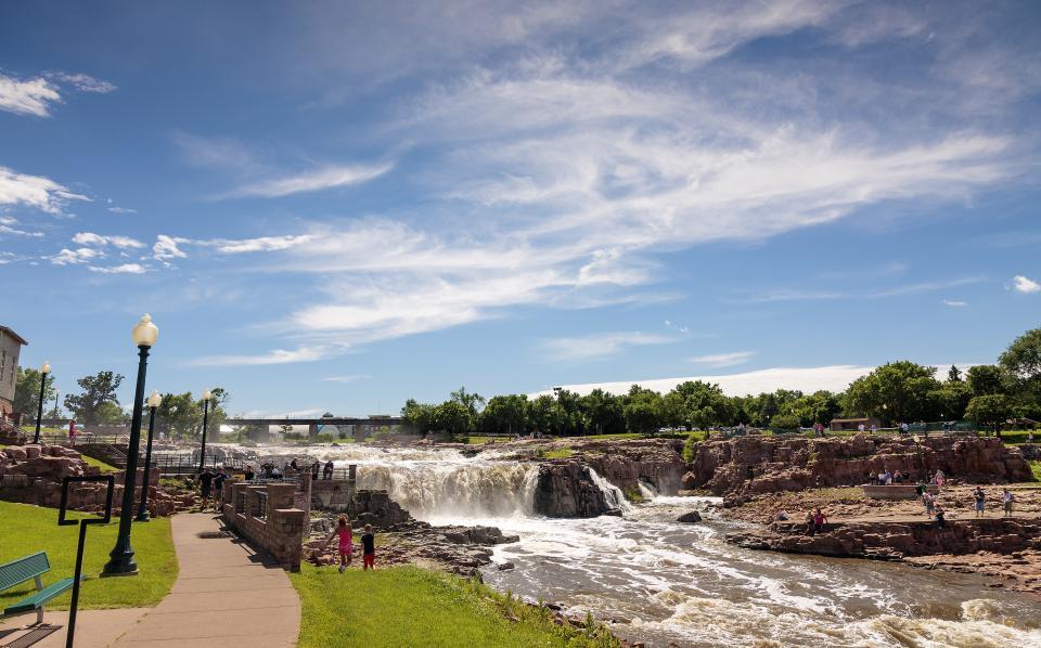 People enjoying a riverside park in southeast SD.