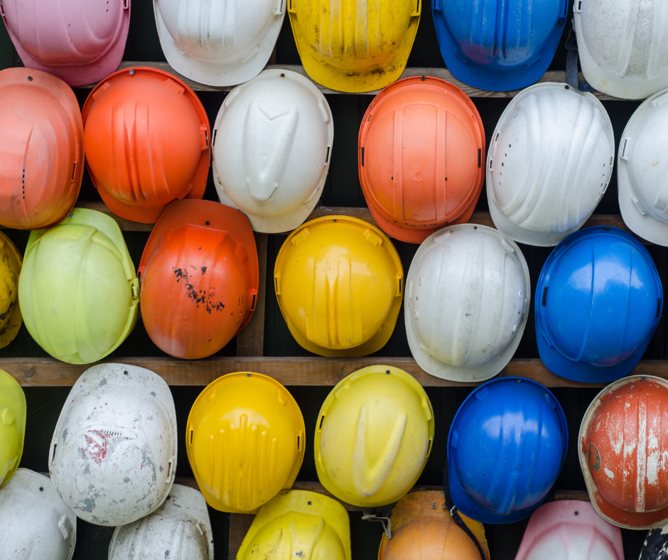 construction hard hats lined up next to each other in different colors representing economic development projects in South Dakota