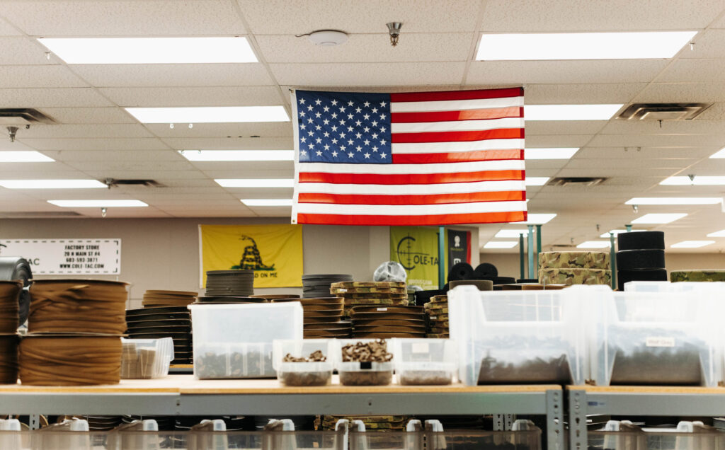 Cole-TAC factory with large American flag hanging over the shop