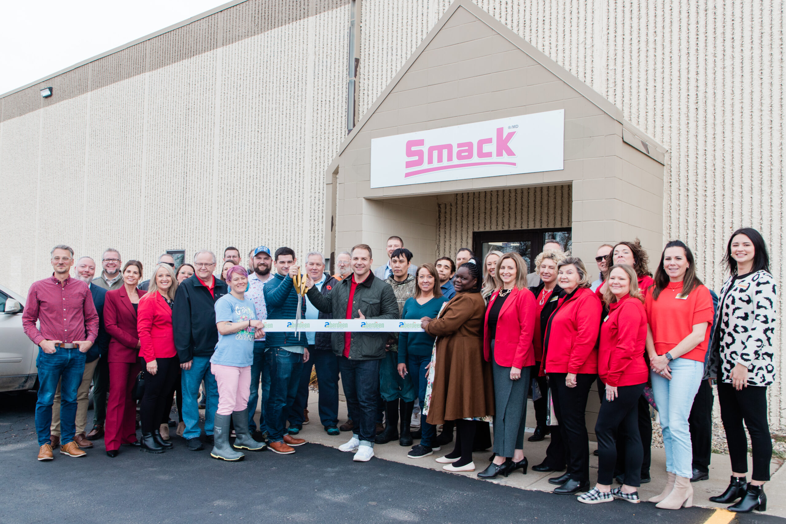 Smack ribbon cutting ceremony moment in front of building